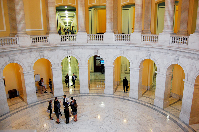 Small group of people standing inside US Capitol rotunda 