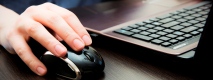 Using a laptop with a mouse.