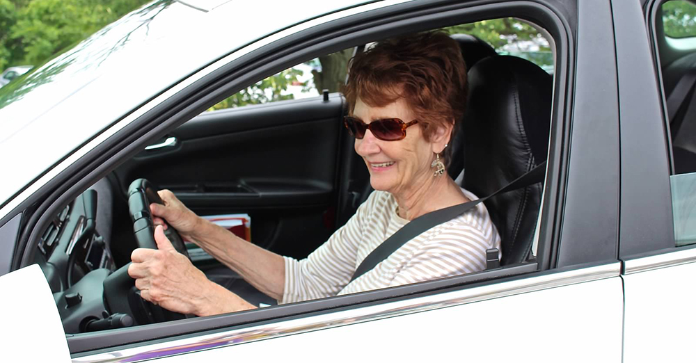 an older adult driving a car