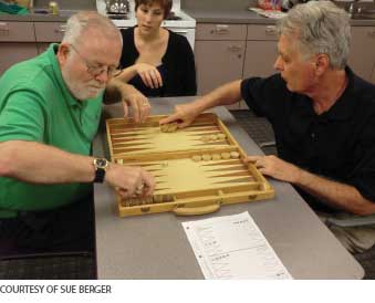Two older adults playing a game.